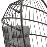 Schwarzer Rattan Hängesessel in Eiform mit gepolstertem, grauem Kissen, ideal für entspannende Momente im Innen- und Außenbereich