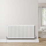 Weißer Gliederheizkörper mit TRV Chromventilen, 600mm x 1200mm, elegant an der Wand montiert, umgeben von einem hellen Wohnraum mit Holzfußboden