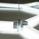 Sechseckige LED-Leuchte mit transparentem Rahmen, klaren Kanten und einem stabilen Aufhängesystem, ideal für moderne Garagenbeleuchtung